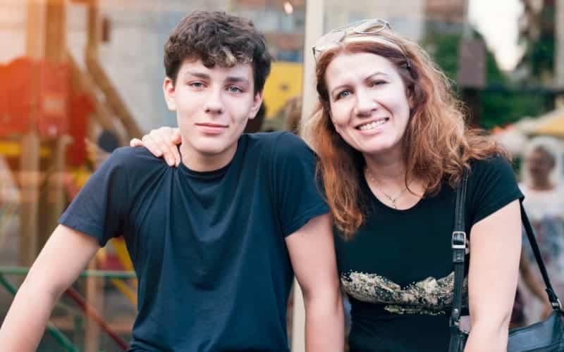 A mom sits with her teen son